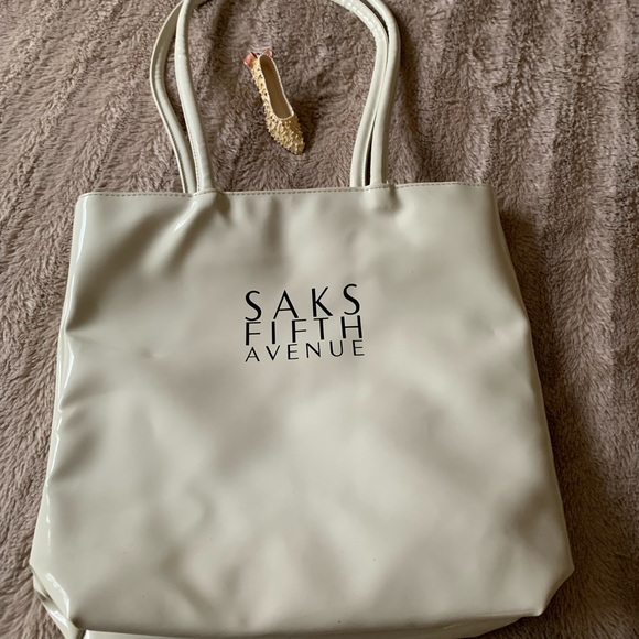 Saks Fifth Avenue Handbags - SAKS Fifth Avenue crème’ color double handle Vinyl tote with Black logo …